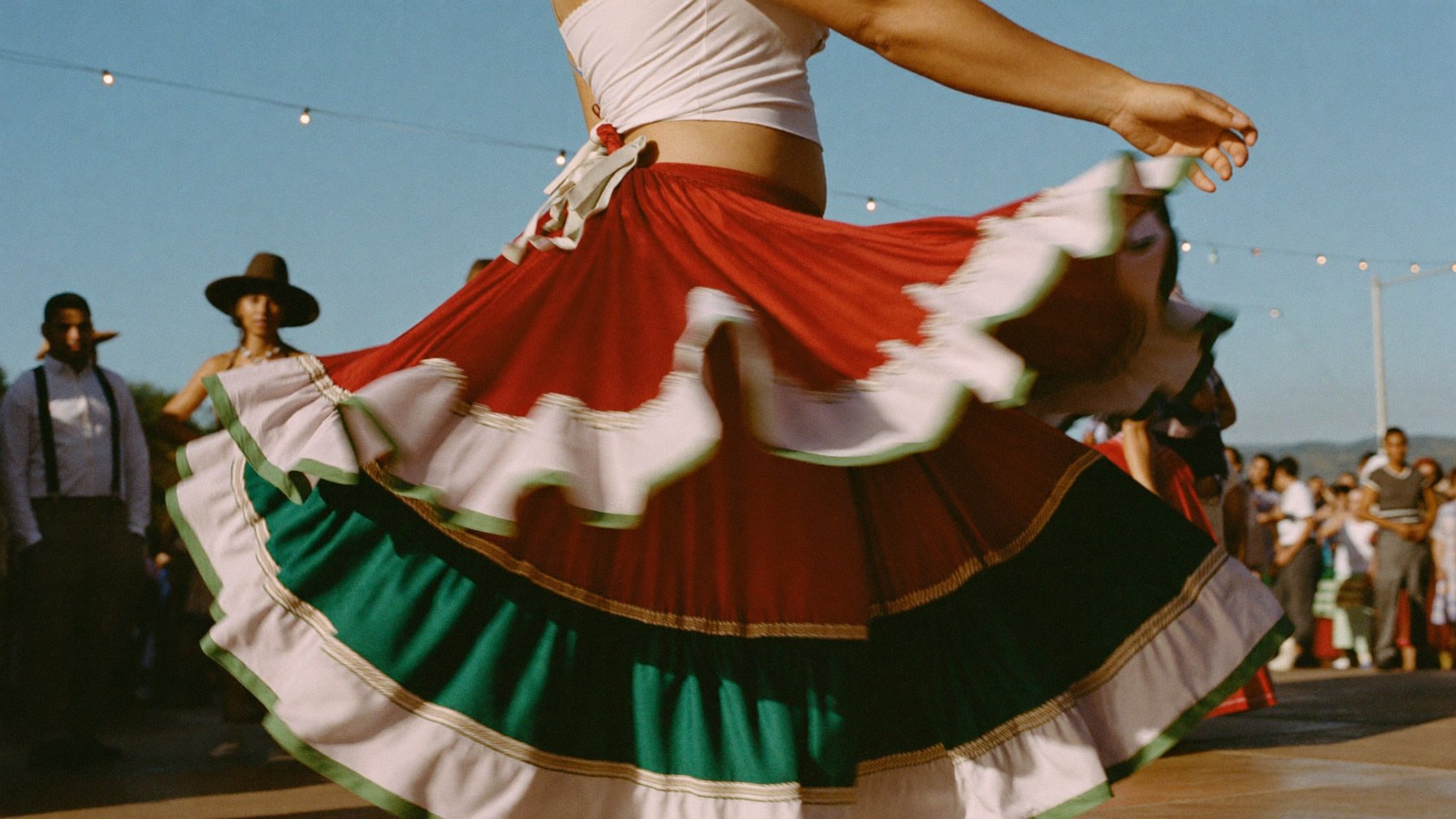 Tricolor Jalisco skirt spinning at an outdoor Fiestas Patrias folklorico performance