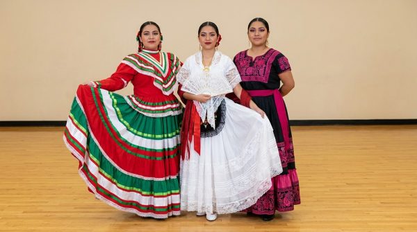 Folkloric dancer in full Jalisco dress with skirt extended during a performance spin